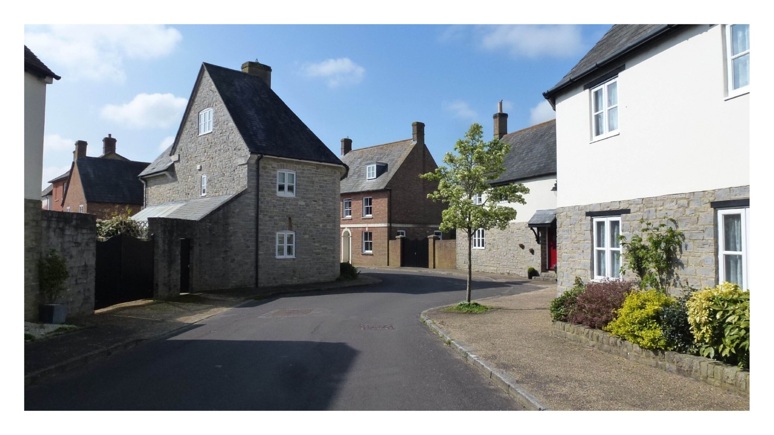 The building line here creates a deflection in the street calming traffic in Poundbury, Dorset. (Andy Cameron)
