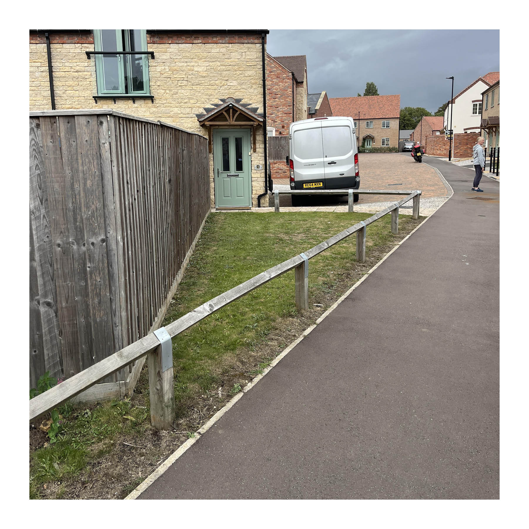 Leftover space serving no purpose and creating a maintenance burden. Note the garden fence backing onto the street.