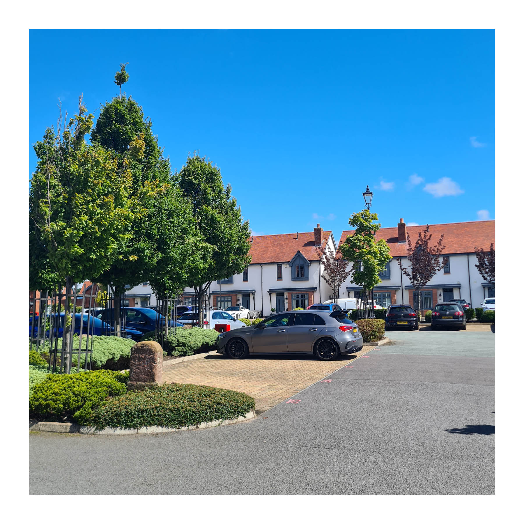 A green and attractive parking square in Neston, Cheshire.