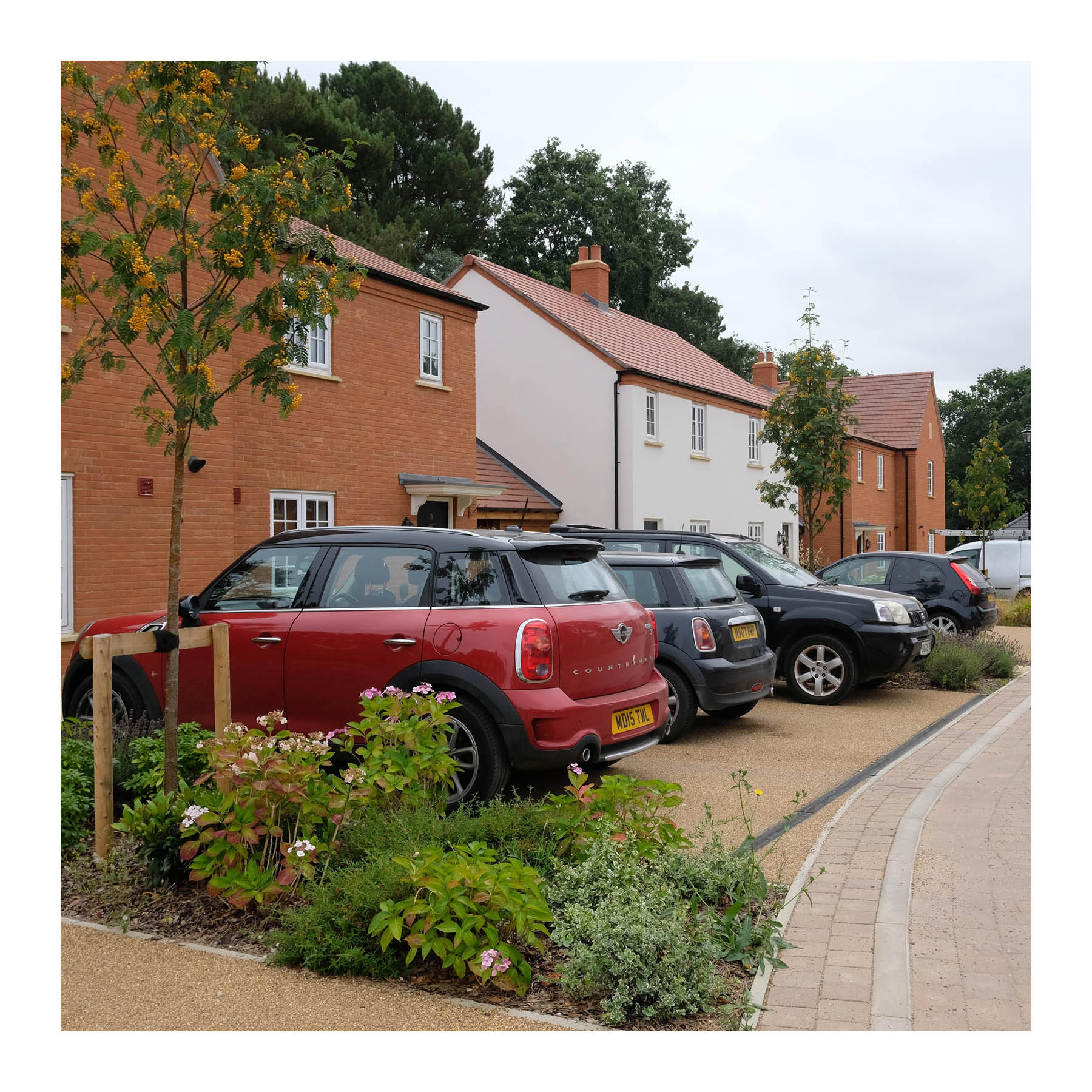 Greenery, including trees, used to soften driveway parking in Houghton Grange, Huntingdon (Homes England)