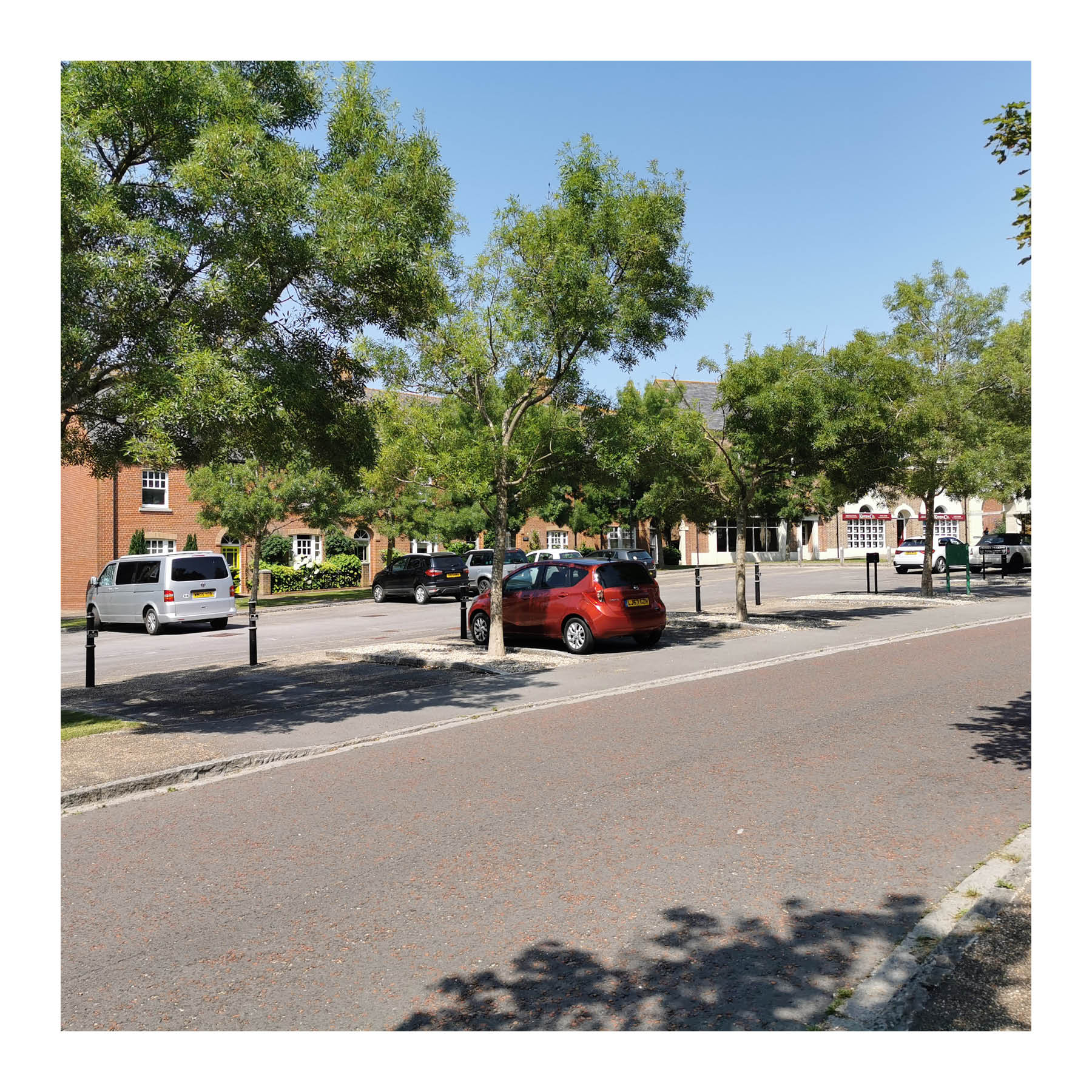 Trees used to soften a parking courtyard in Poundbury, Dorset.