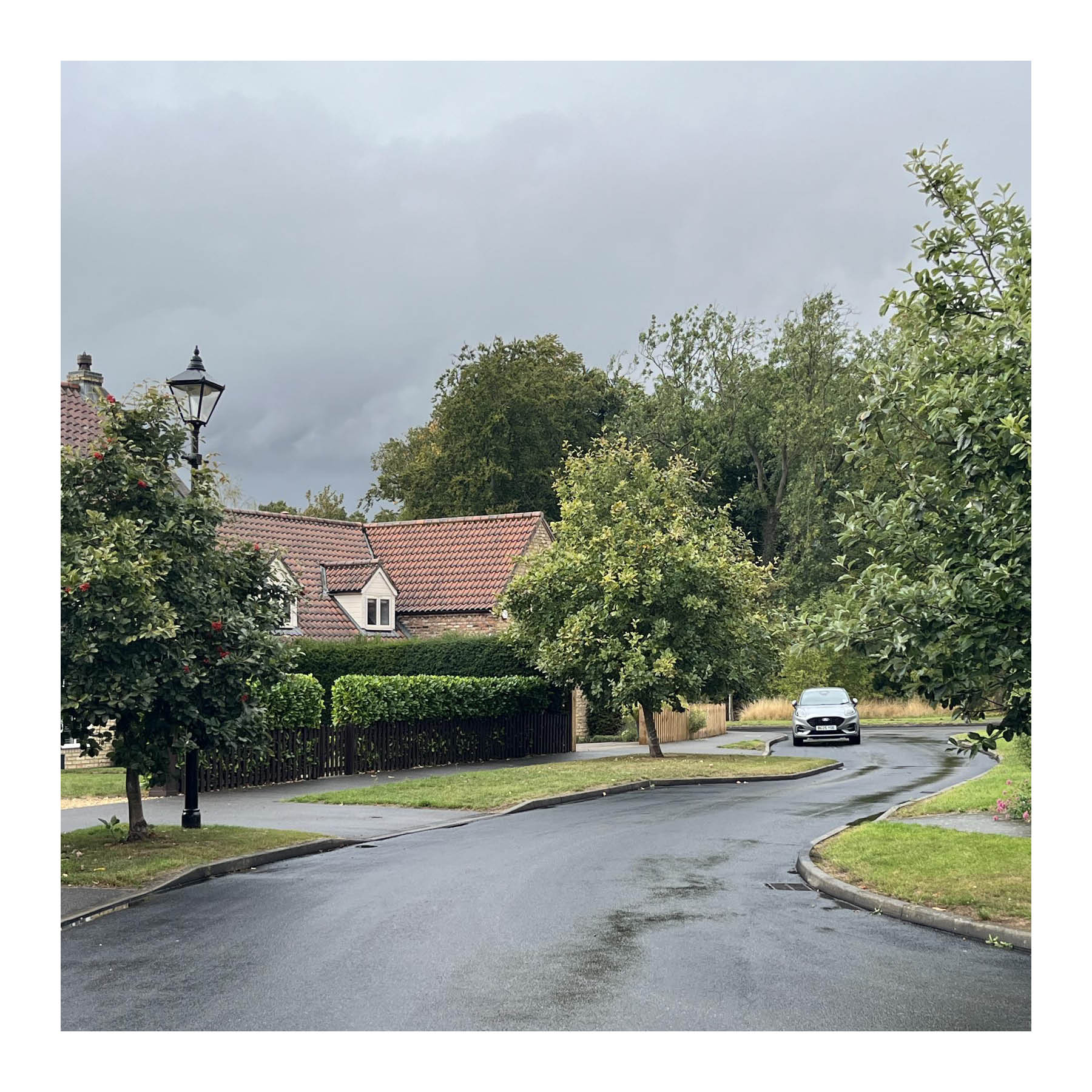 Winding streets with varying widths and regular trees in Harmston encourage slower driving