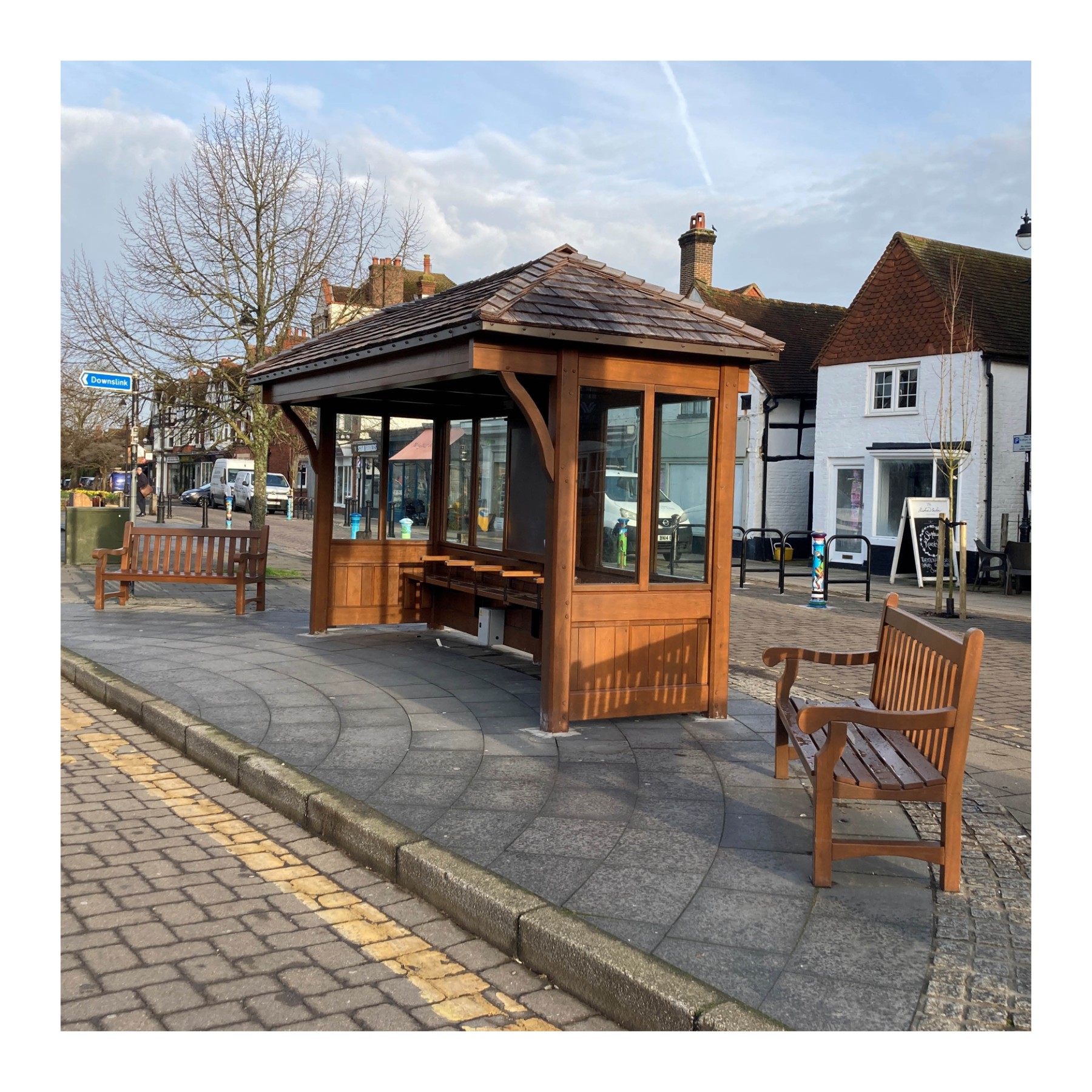 A new bus shelter in a village setting, with additional seating. (Surrey County Council)