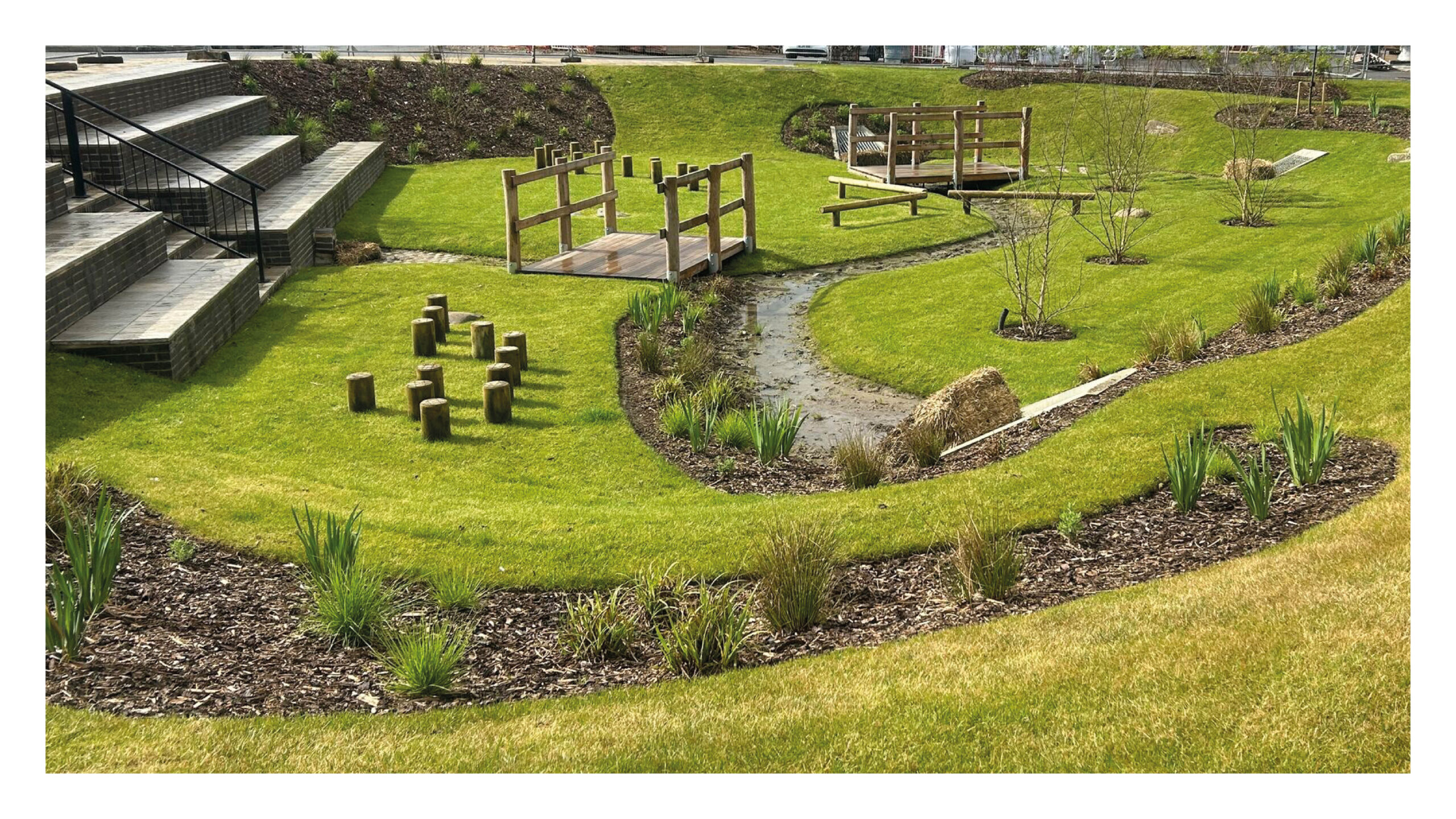 A multifunctional SuDS basin in the heart of a new development, incorporating play and biodiverse planting. Montem Square, Slough ([Miracle Design and Play](https://www.miracledesignandplay.co.uk/)).