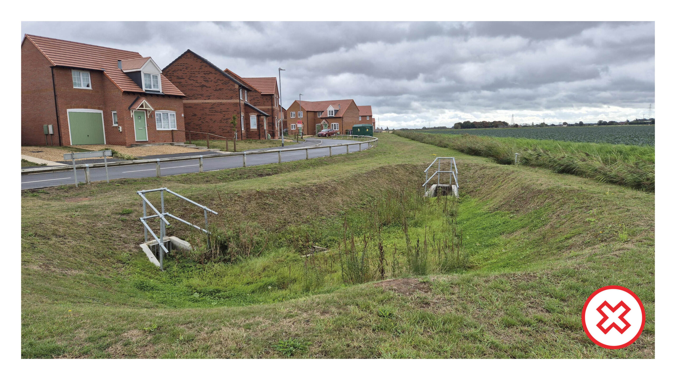 A poorly designed 'bomb crater' pond with fencing, poor planting and ugly headwalls.
