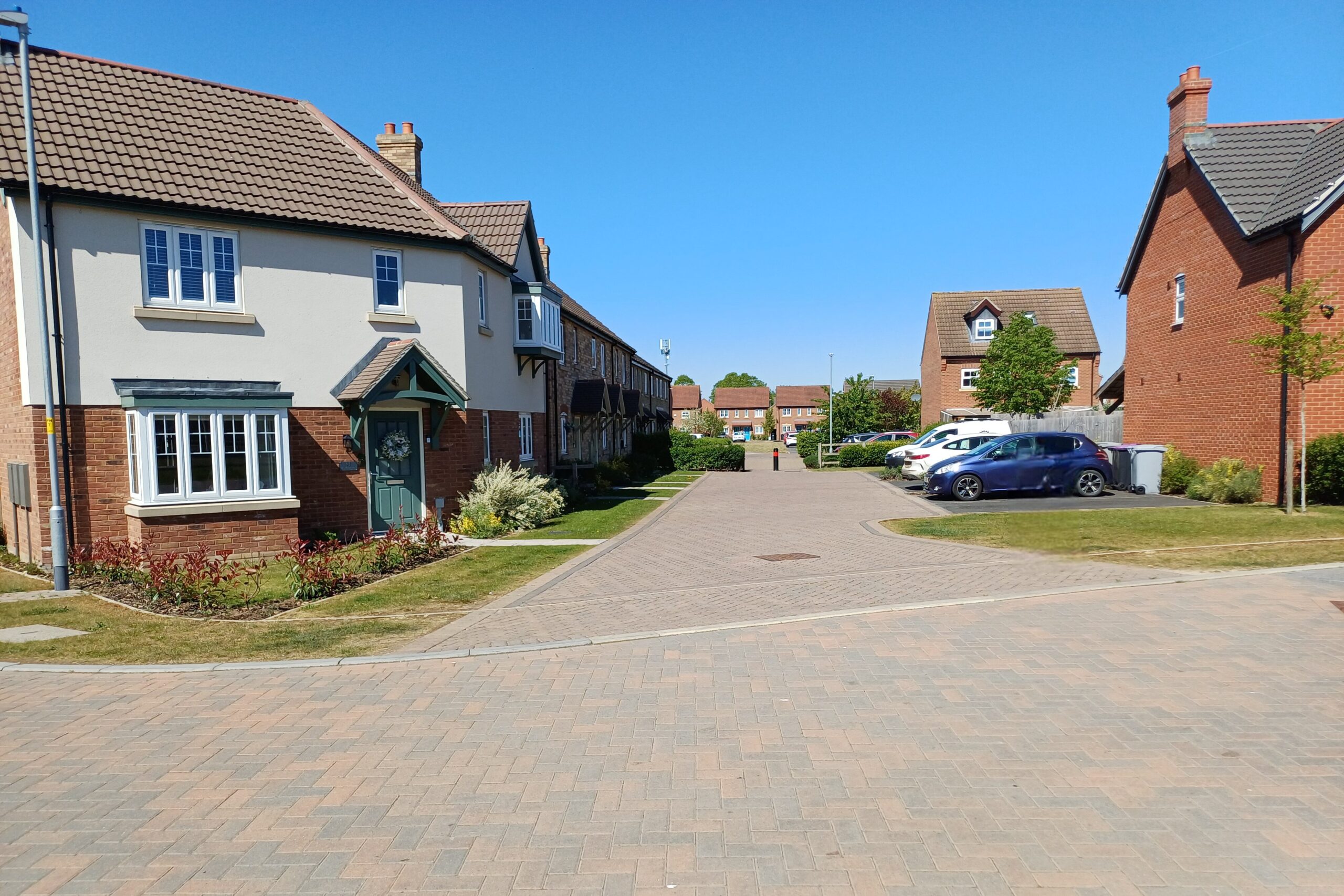 Coningsby, with shared surface block-paving, modal filter and parking bays.